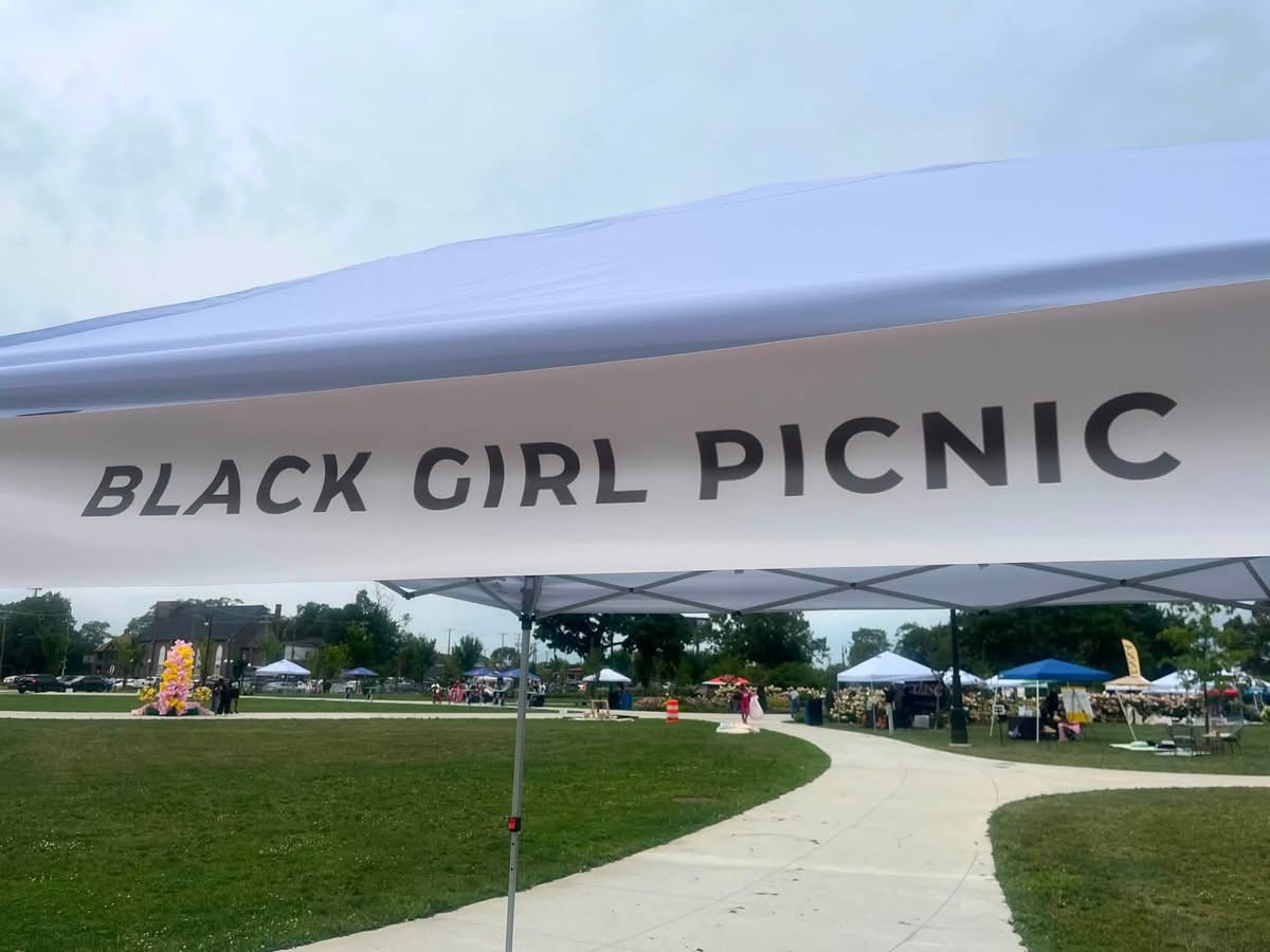 Black Girl Picnic sign above a gathering in the park