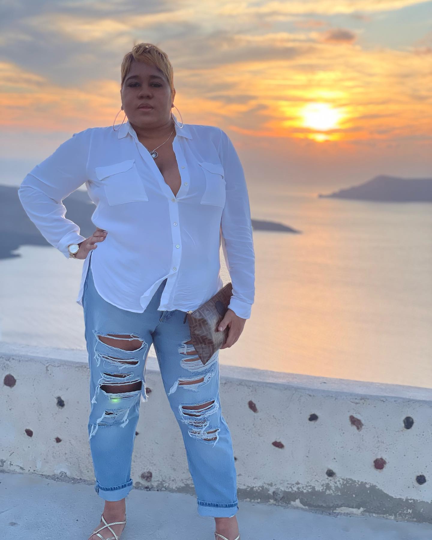 Regina standing in front of a sunset ocean view